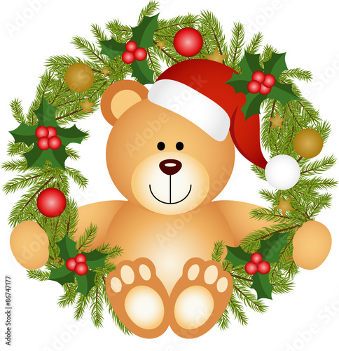 Teddy bear sitting in a Christmas wreath