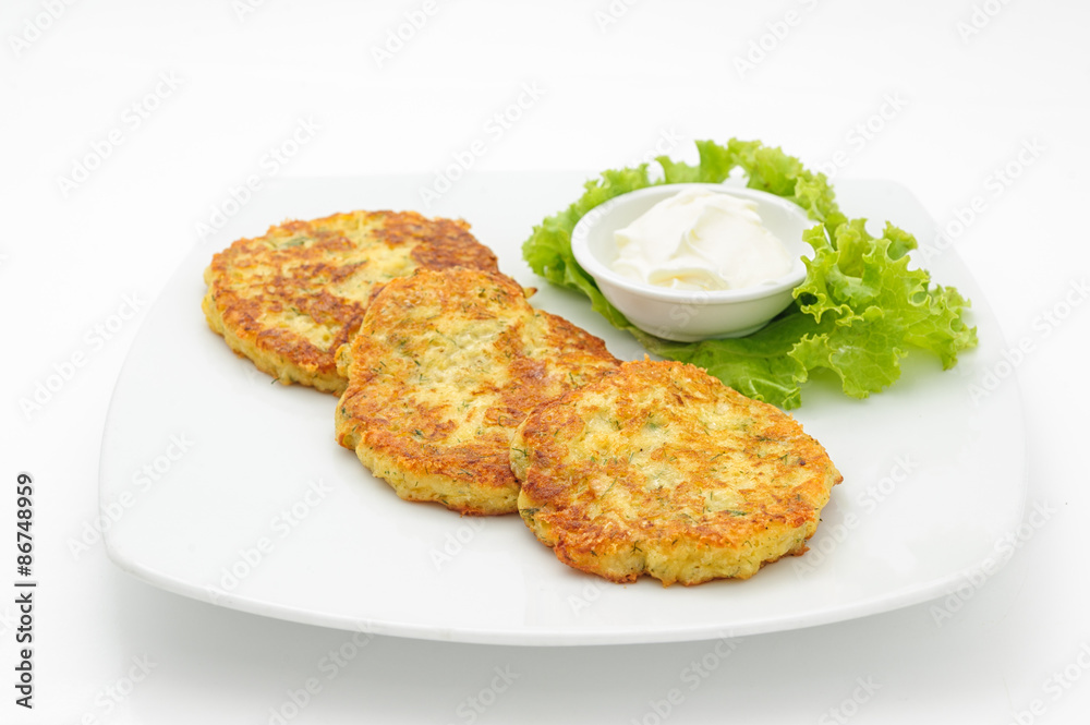 Potato cutlets with sour cream isolated on white. Potato cutlets with sour cream isolated on white.