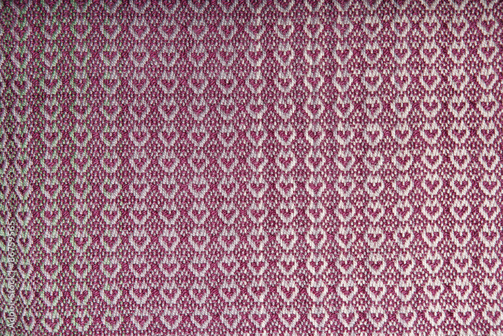 Handmade fabric with pink and violent hearts texture. Clothes background