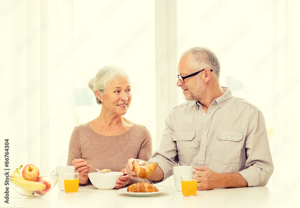 happy senior couple having breakfast at home