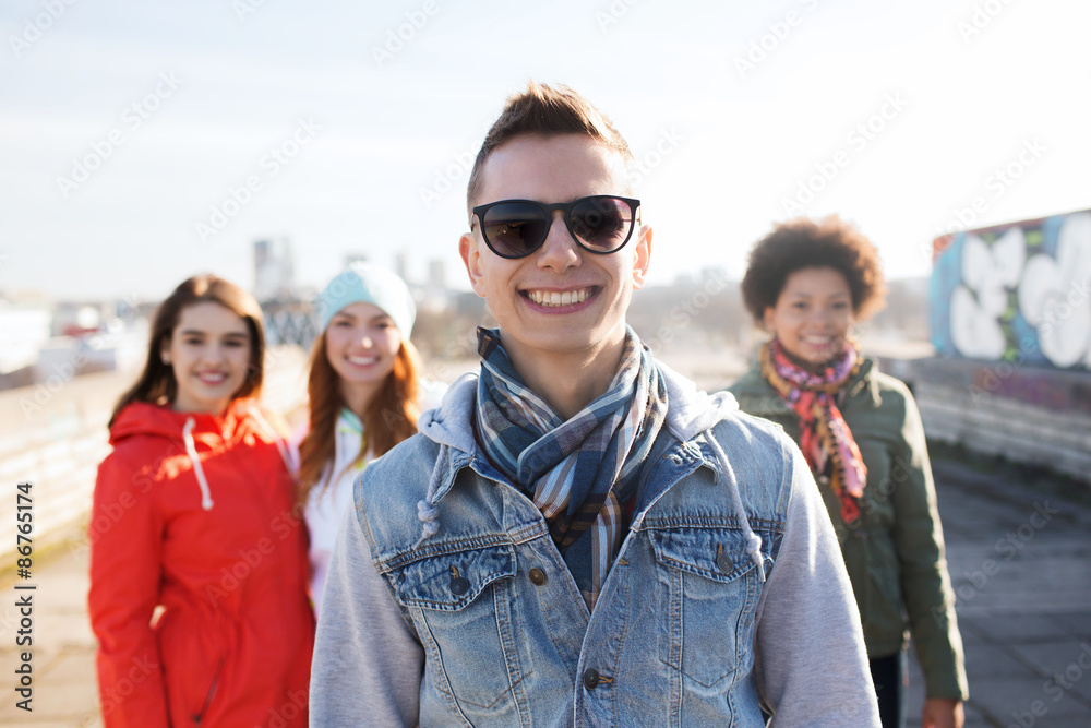 group of happy teenage friends on city street