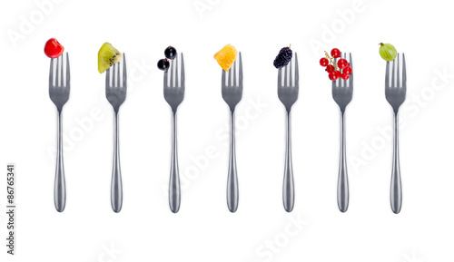 berries on forks isolated on white background