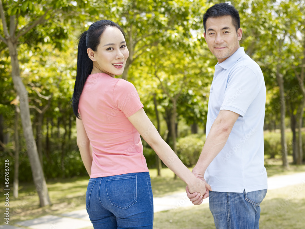 young couple holding hands young couple holding hands