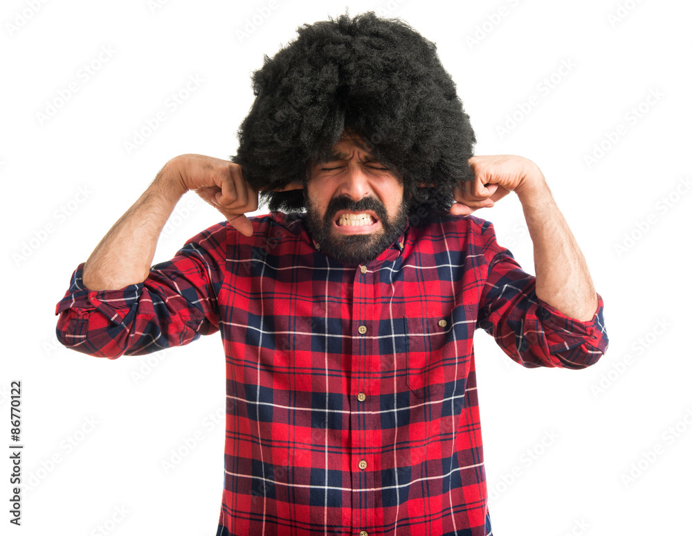 Afro man covering his ears Afro man covering his ears