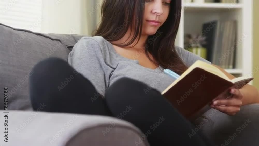 Mixed race woman writing in her diary Mixed race woman writing in her diary
