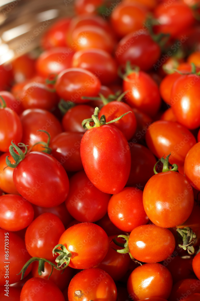 Group of fresh tomatoes in basket.