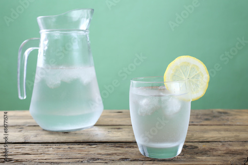 acqua bicchiere e caraffa di vetro trasparente sfondo rustico photo