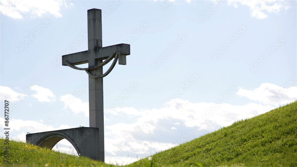 Cross behind green hills Cross behind green hills