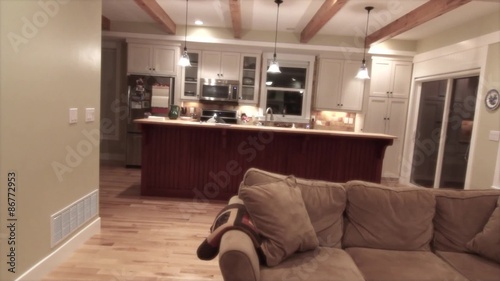 a living room and a kitchen in a country house jib shot