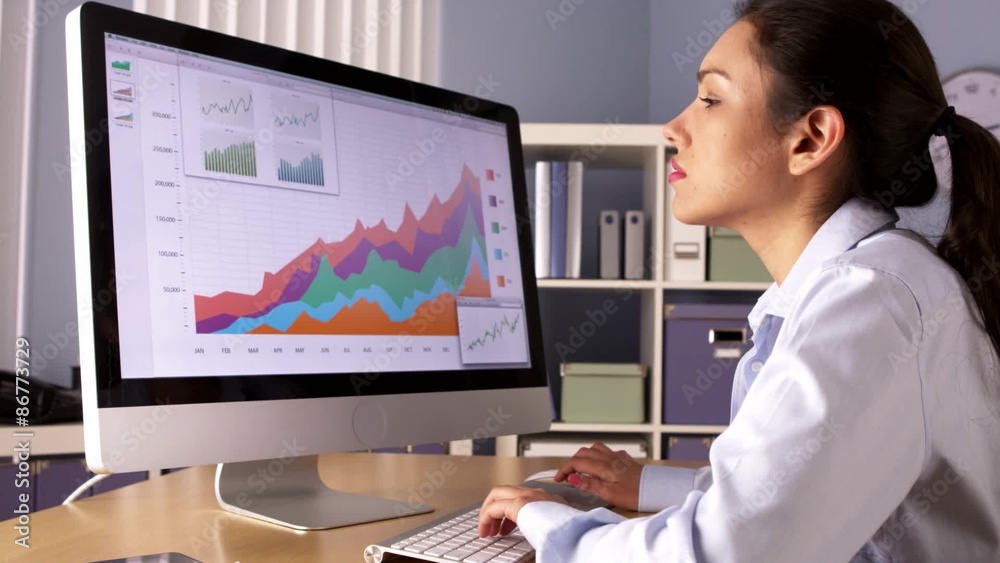 Hispanic businesswoman working overtime 