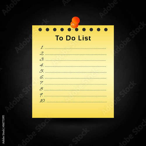 Yellow paper and push pin on black chalkboard background