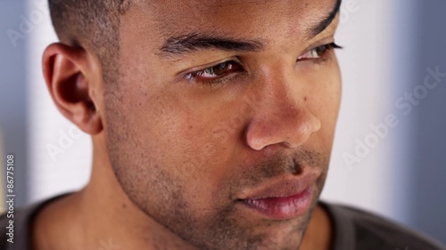 Black man looking out window