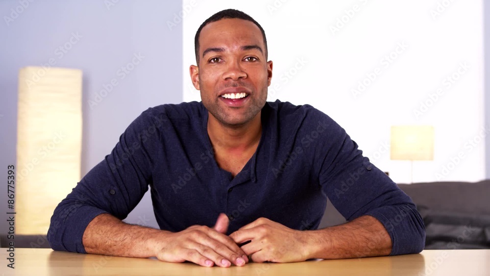 Happy African man talking to camera
