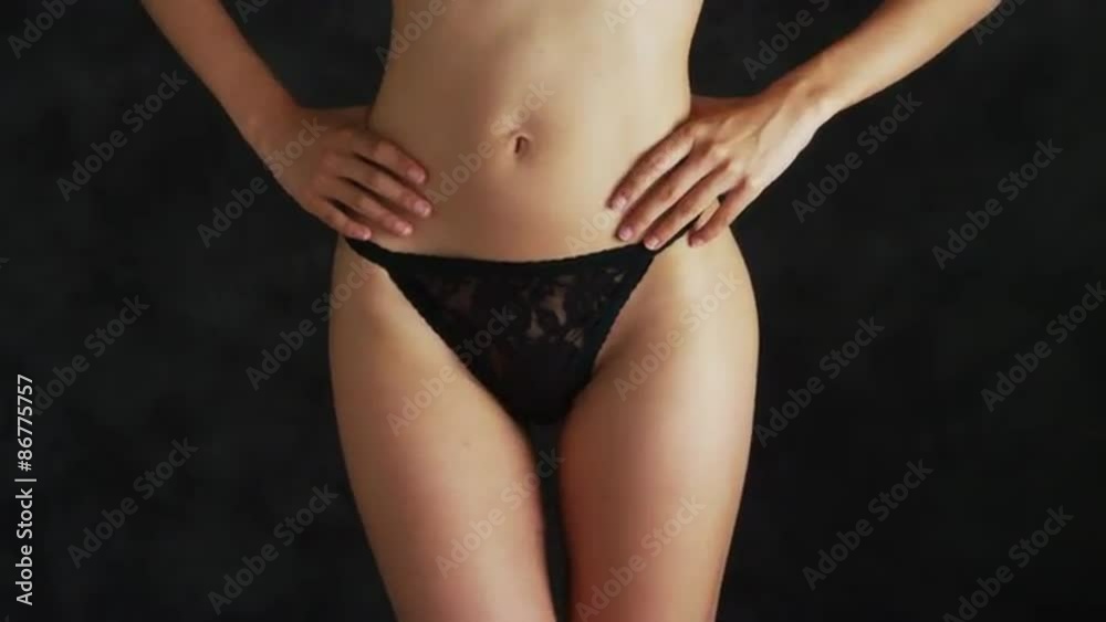 Slender woman wearing a lacey thong Slender woman wearing a lacey thong