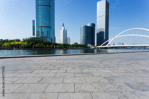 modern buildings and empty road in urban city at riverbank © zhu difeng