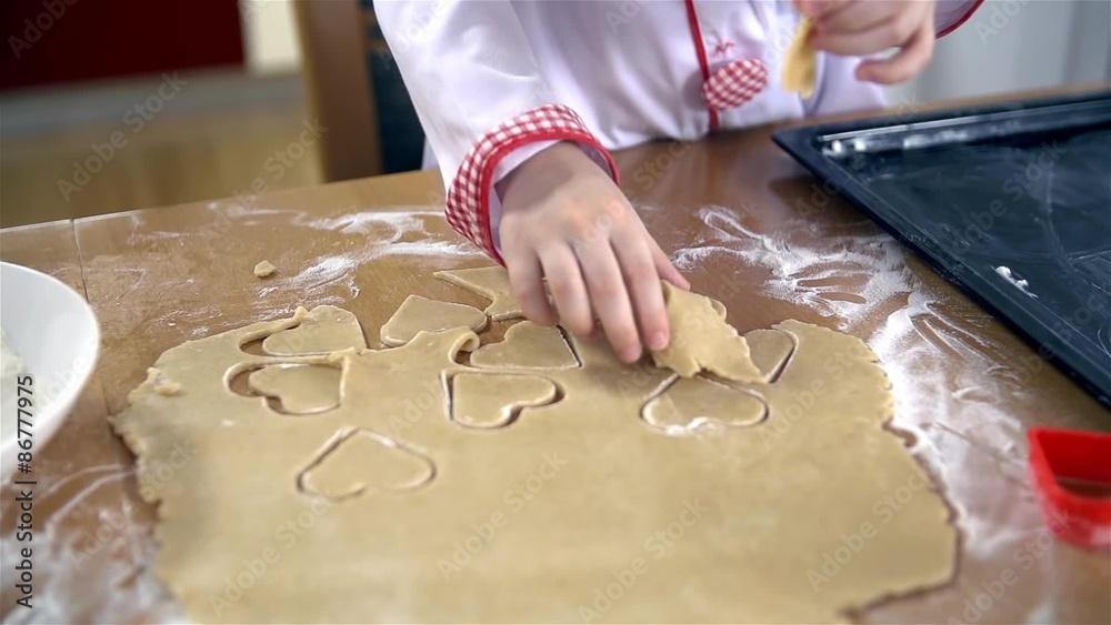 Close up of removing dough around heart shape cookies Close up of removing dough around heart shape cookies