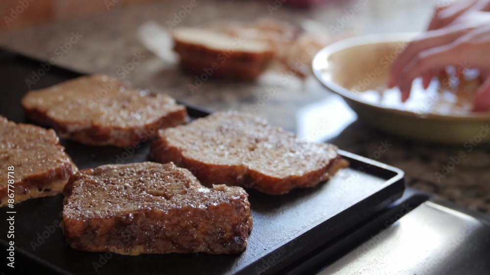 A woman making french toast