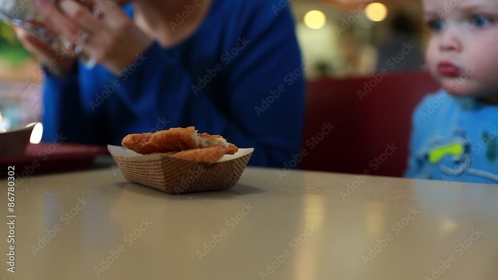 little boy eating chicken strips little boy eating chicken strips