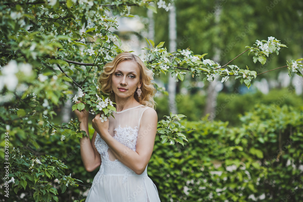 The beautiful girl in a dress among blossoming trees 3140. The beautiful girl in a dress among blossoming trees 3140.