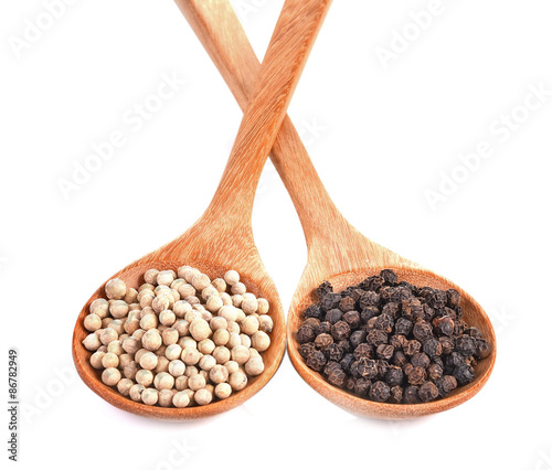 Black Pepper ,White Pepper Corns in wooden spoon isolated white