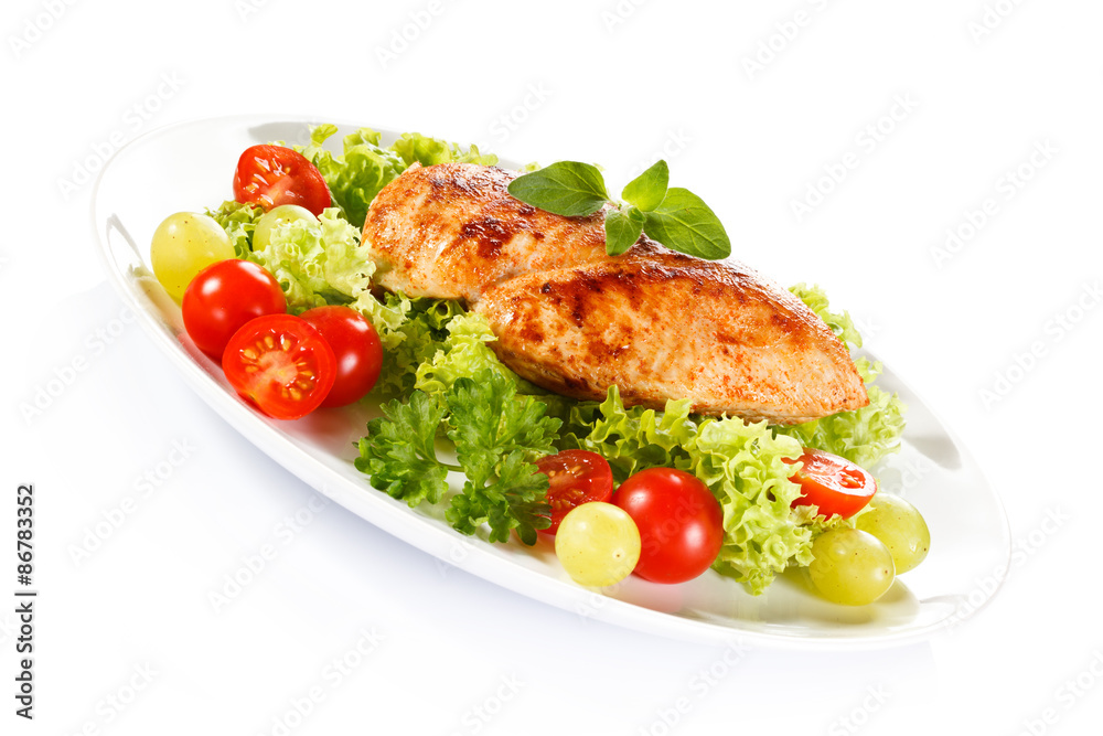 Roast chicken fillet and vegetables on white background Roast chicken fillet and vegetables on white background