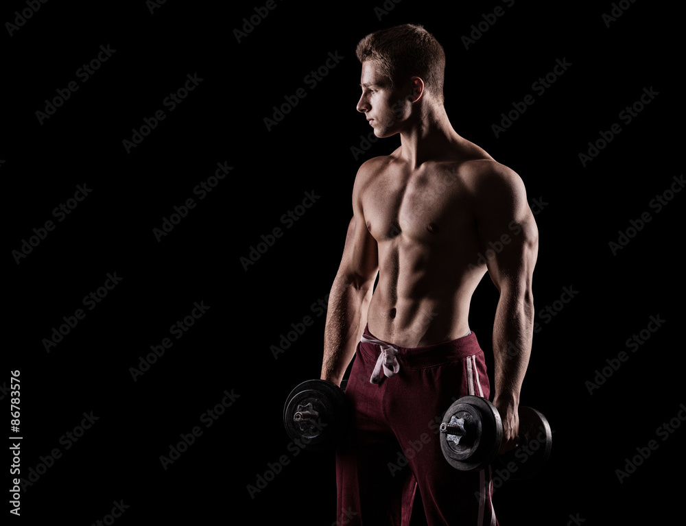 athletic young caucasian man in studio on black background with