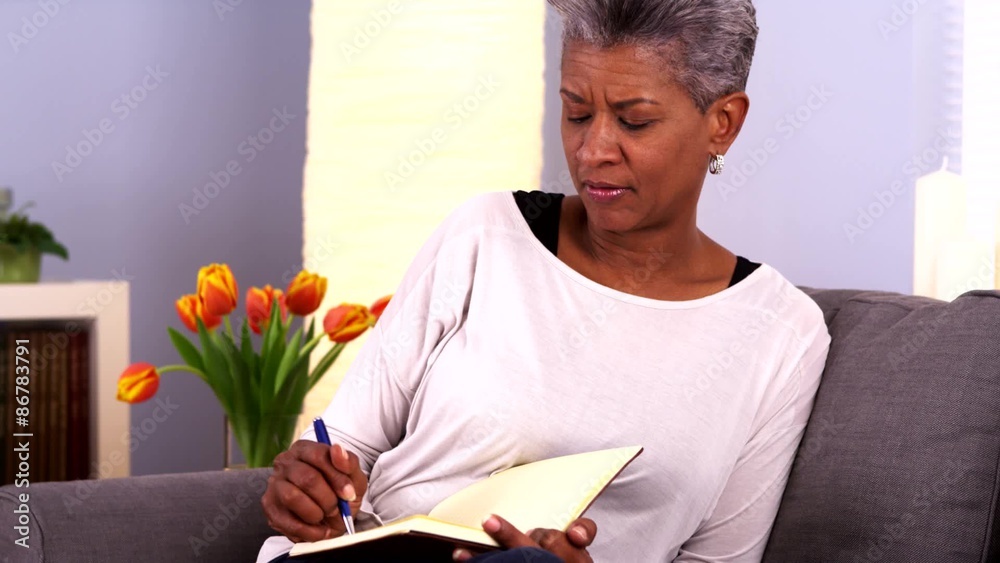 Mature black woman writing in journal