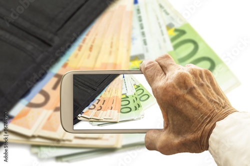 Old hand takes a picture of wallet with euro banknotes on smart