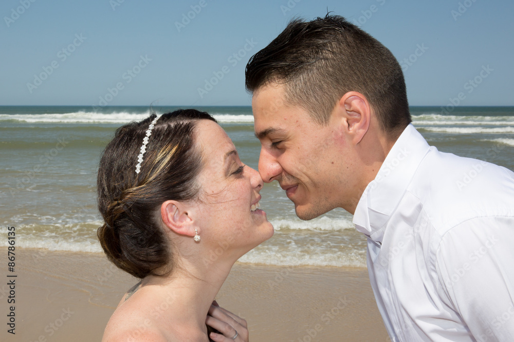 Beautiful couple at the beach happy together Beautiful couple at the beach happy together