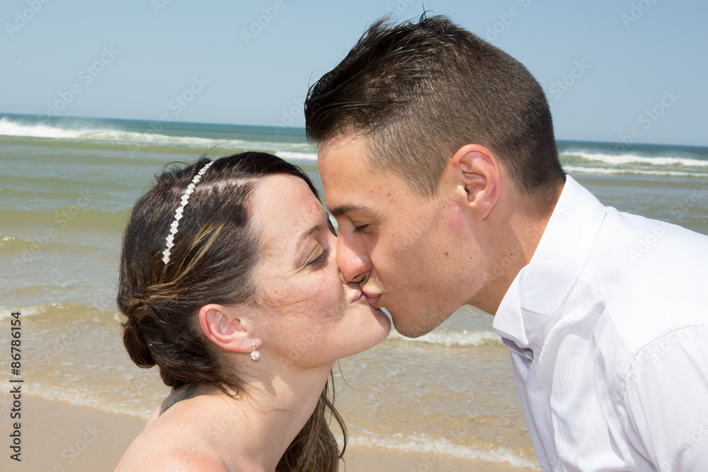 Beautiful couple at the beach happy together Beautiful couple at the beach happy together