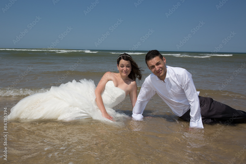Beautiful couple at the beach happy together Beautiful couple at the beach happy together