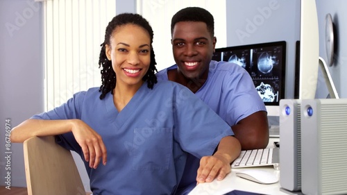 African American medical personell sitting together at computer photo