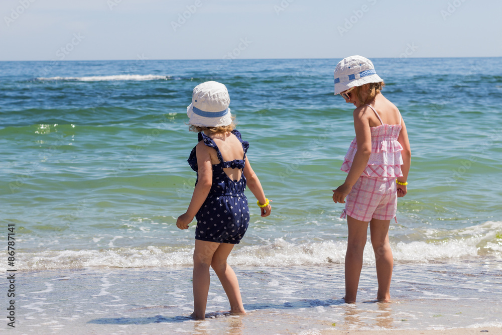 Beautiful little girls (sisters) are running and playing on the Beautiful little girls (sisters) are running and playing on the