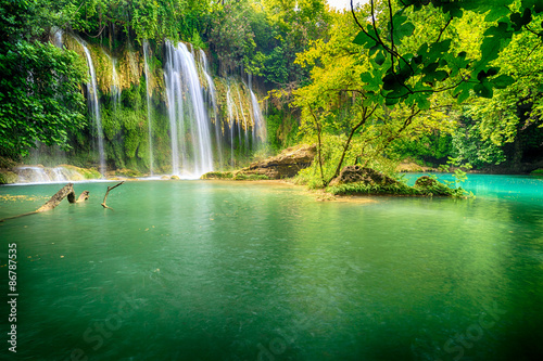Fototapeta Naklejka Na Ścianę i Meble -  a beautiful waterfall in the forest on a river