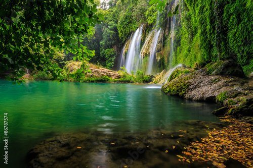 Fototapeta Naklejka Na Ścianę i Meble -  a beautiful waterfall in the forest on a river