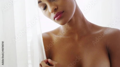 Sexy topless black woman  looking out woman photo