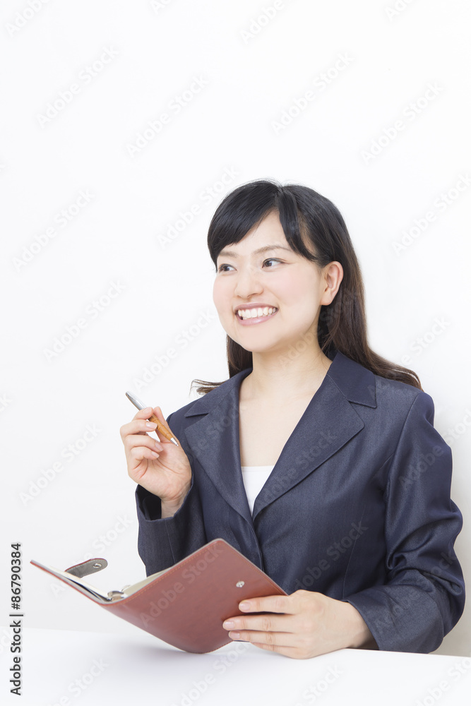 手帳を持って考える女性 手帳を持って考える女性