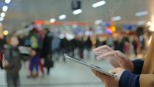 Using tablet computer at the airport hall