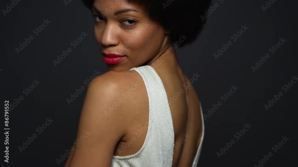 Black woman wearing white gown looking over shoulder Black woman wearing white gown looking over shoulder