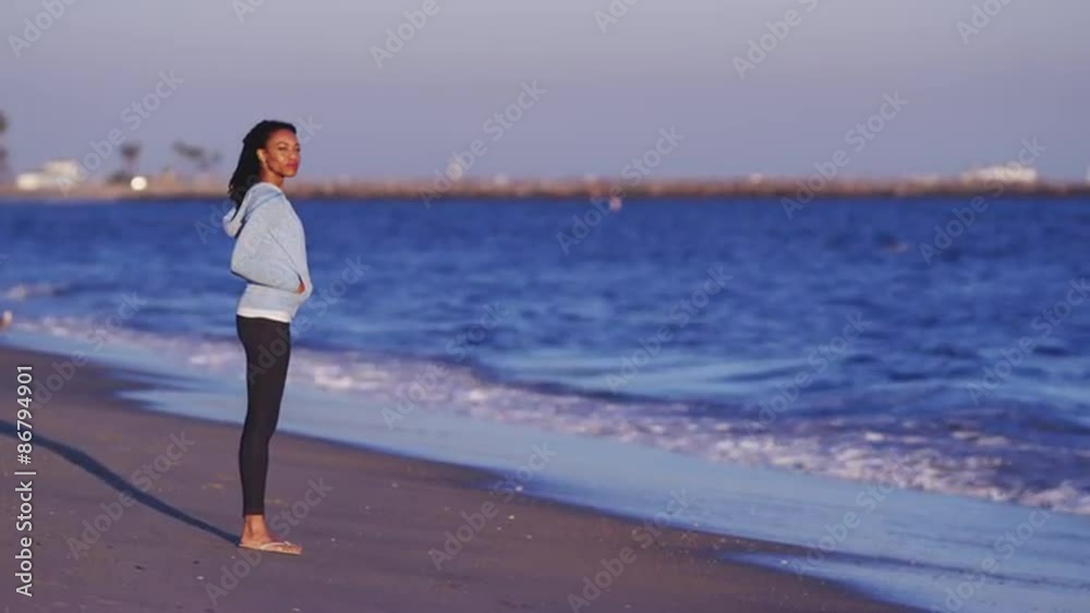 Black woman enjoying the ocean view until waves come Black woman enjoying the ocean view until waves come