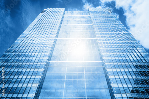 Sun reflecting in modern business skyscraper, high-rise building,