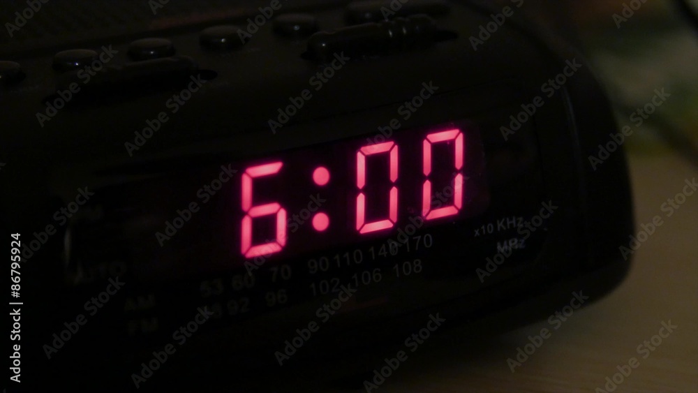 Man hits snooze on alarm clock