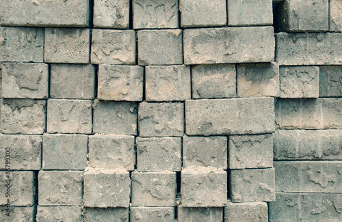 Grey square bricks stacked in rows in the center of city