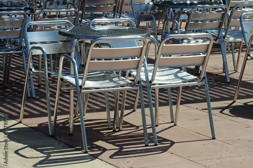 Street Cafe empty aluminium chairs.