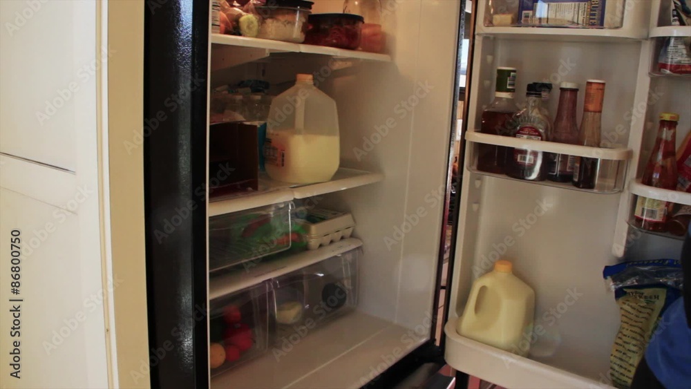 Man takes milk out of fridge Man takes milk out of fridge