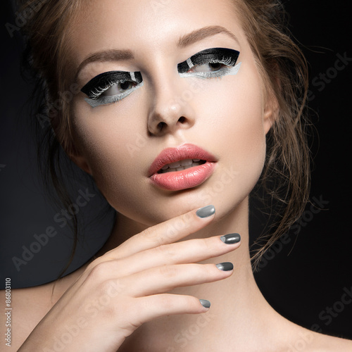 Beautiful girl with bright creative fashion makeup and Grey nail
