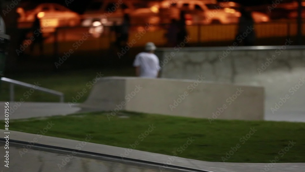 teen skateboarder at skate park night