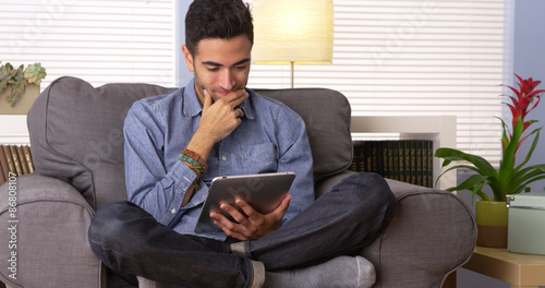 Photos Puerto Rican man reading an e-book on his tablet