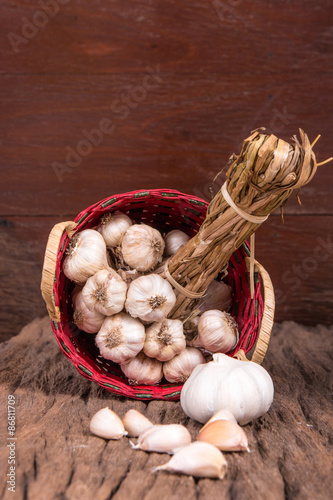 Garlic on Bambboo Basket and wooden Background. photo
