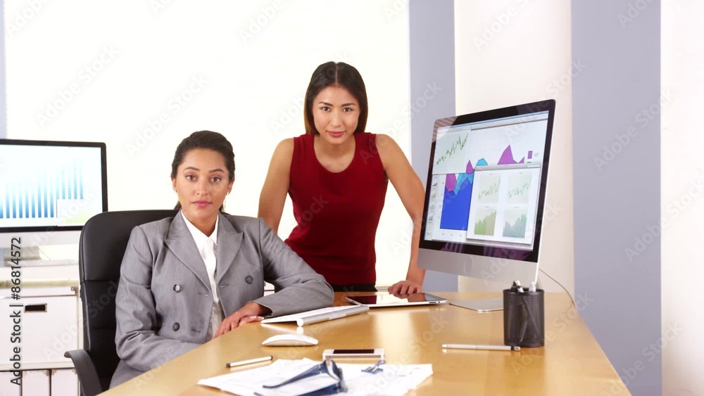 Mixed race business executives looking at camera Mixed race business executives looking at camera